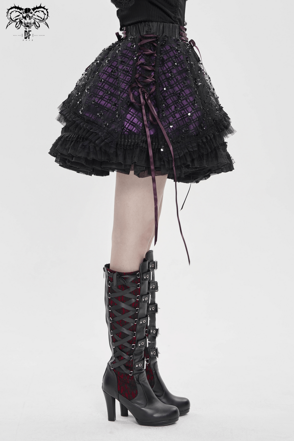 Purple Gothic Tulle Skirt with Lace Up Ribbon Trim paired with stylish boots in a gothic-style look.