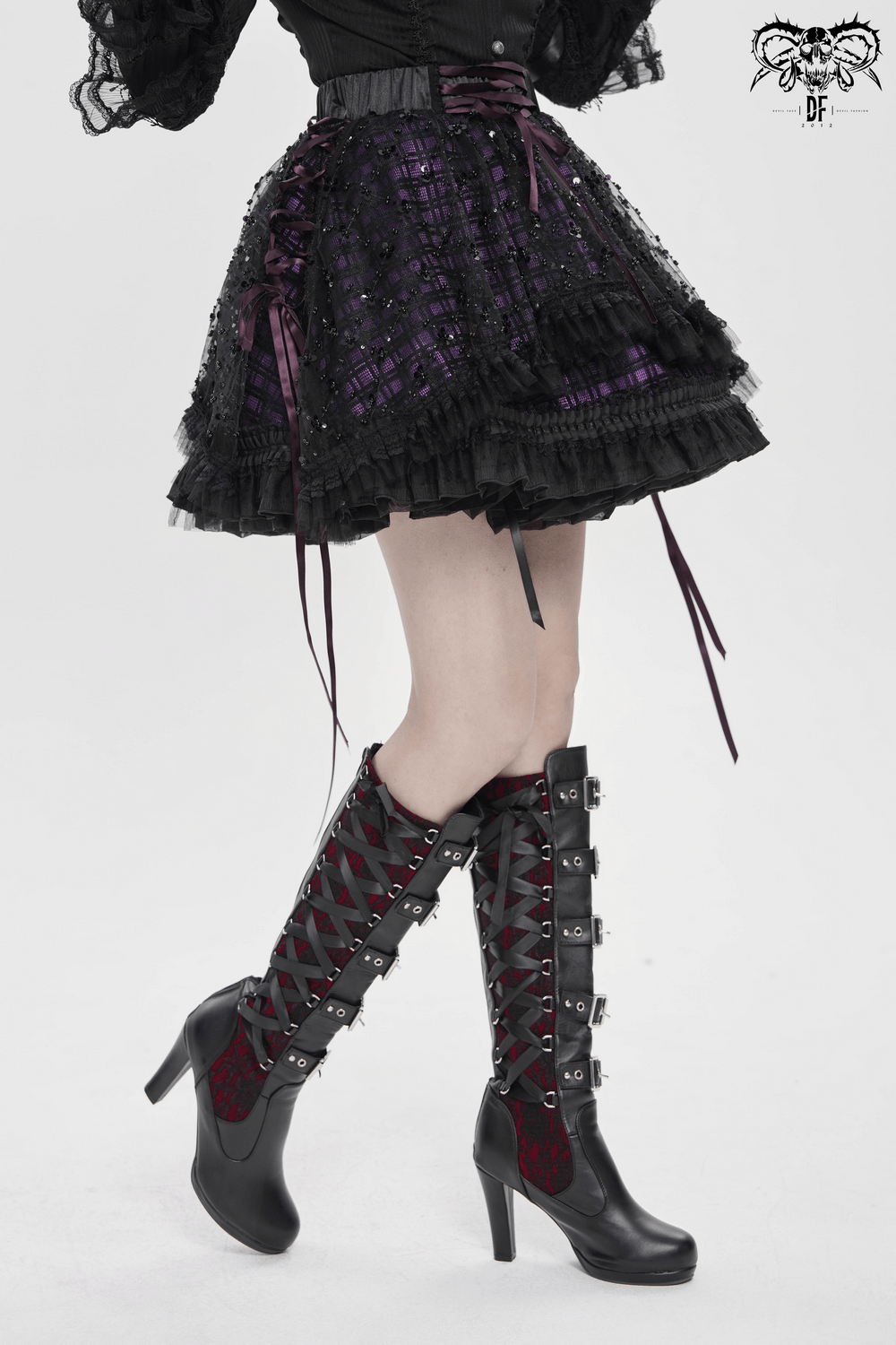 Purple Gothic Tulle Skirt with Lace Up Ribbon Trim styled with knee-high lace-up boots for a dark romantic look.