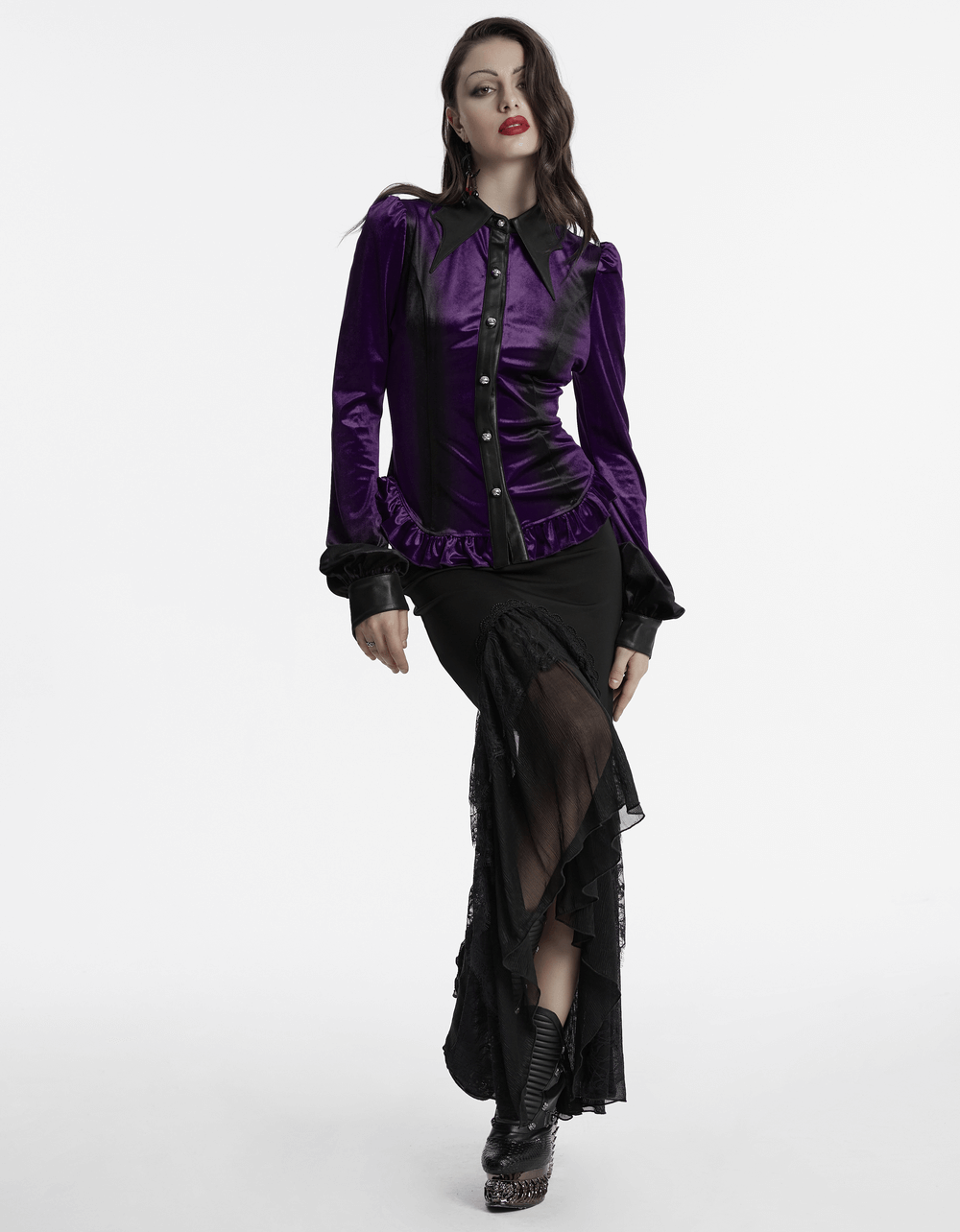 Model wearing a purple gothic velvet shirt with bat collar and ruffle hem, styled with a black skirt and edgy boots.