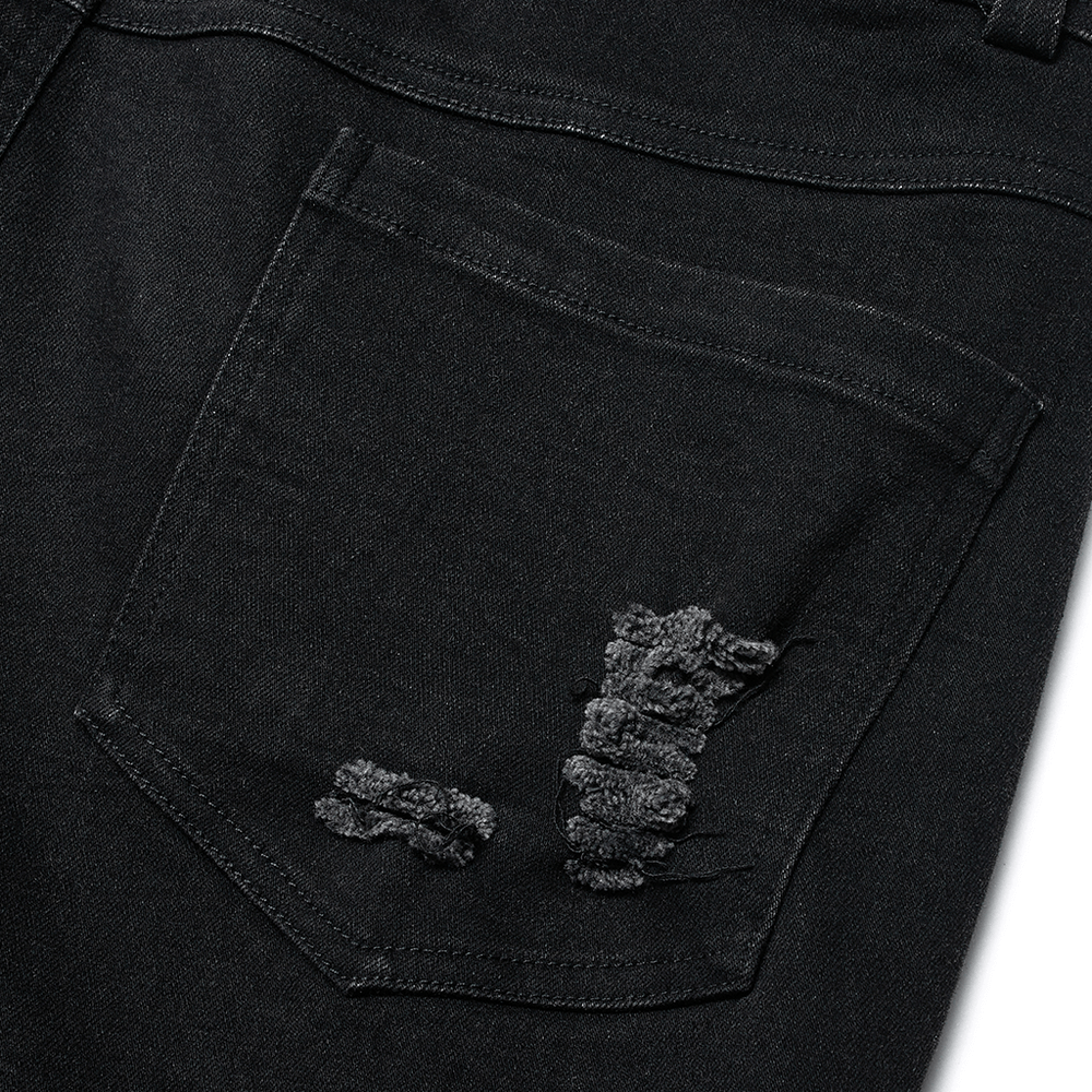 Close-up of ragged black denim trousers showcasing stylish mesh and distressed details.