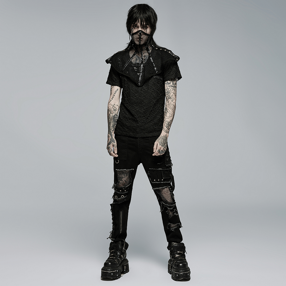 Edgy punk model in ragged mesh splice denim trousers and black top, showcasing a rebellious fashion attitude.