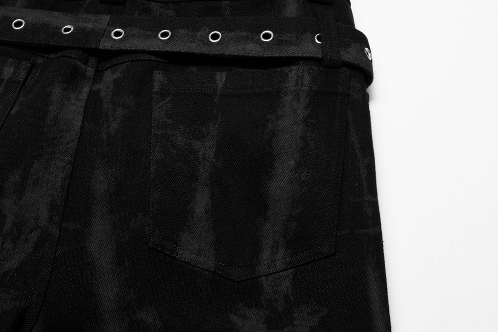 Close-up of punk denim trousers featuring ragged design and metal accents, showcasing edgy style and mesh details.