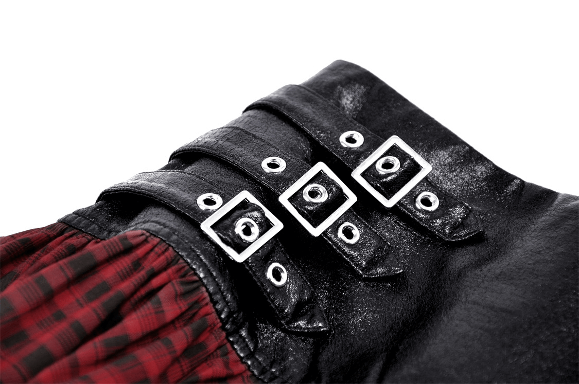 Close-up of black faux leather belt with silver buckles on a red and black tartan gothic mini skirt.