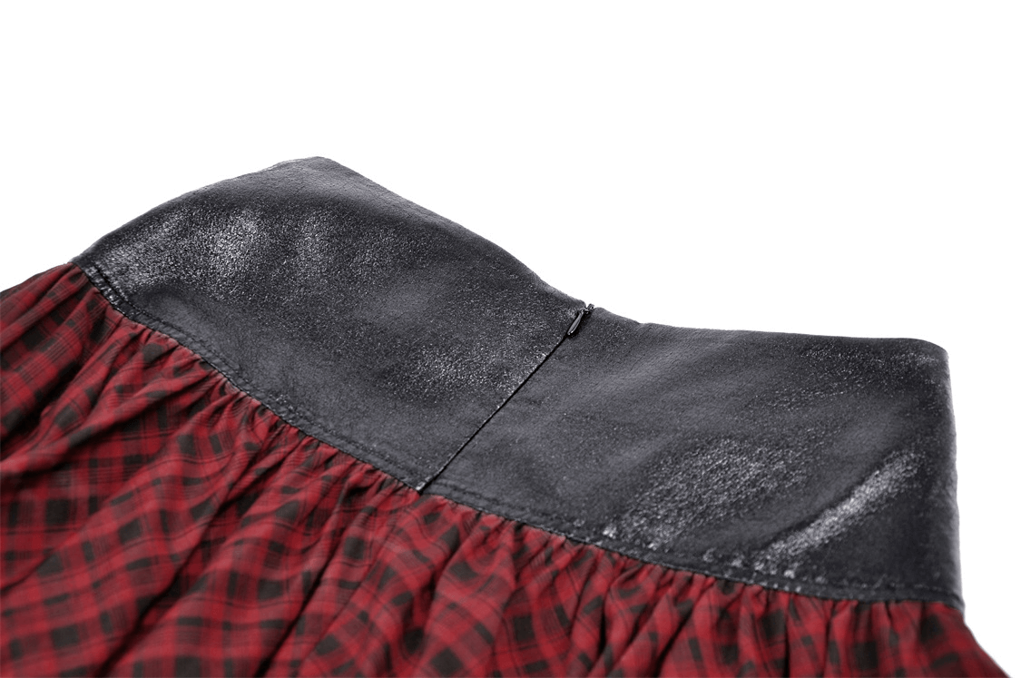 Close-up of the waistband of a red and black tartan gothic mini skirt featuring a faux leather belt.