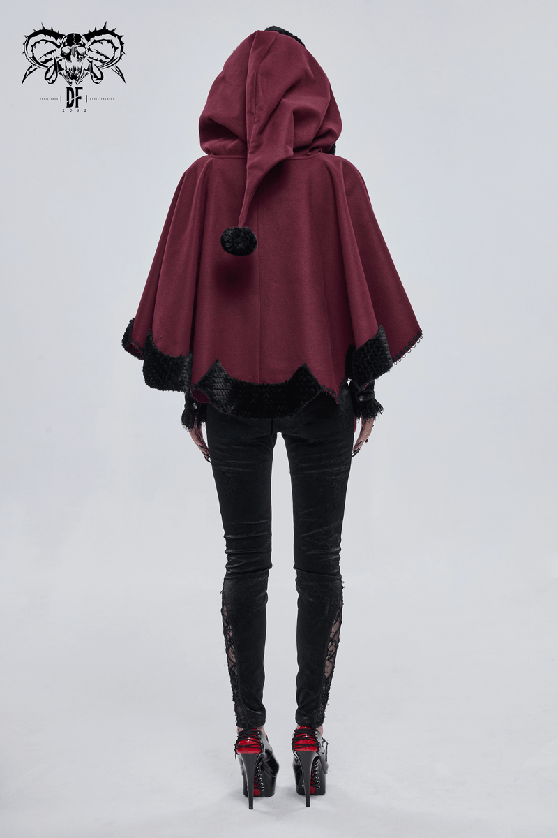 Rear view of a woman in a red gothic hooded cloak with black fur trim and pompons, styled for a unique gothic look.