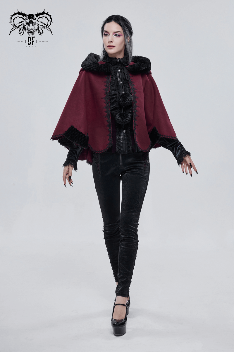 Gothic style red hooded cloak with black fur and pompons, worn by a model for a trendy feminine look.