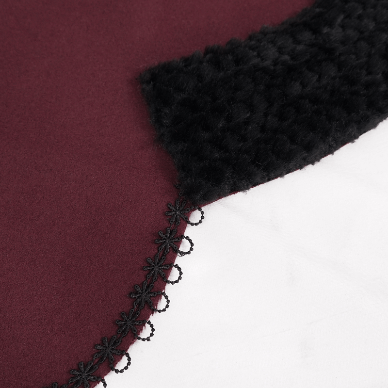 Detail of the red gothic cape with black fur trim and charming black pompoms, perfect for stylish gothic outfits.