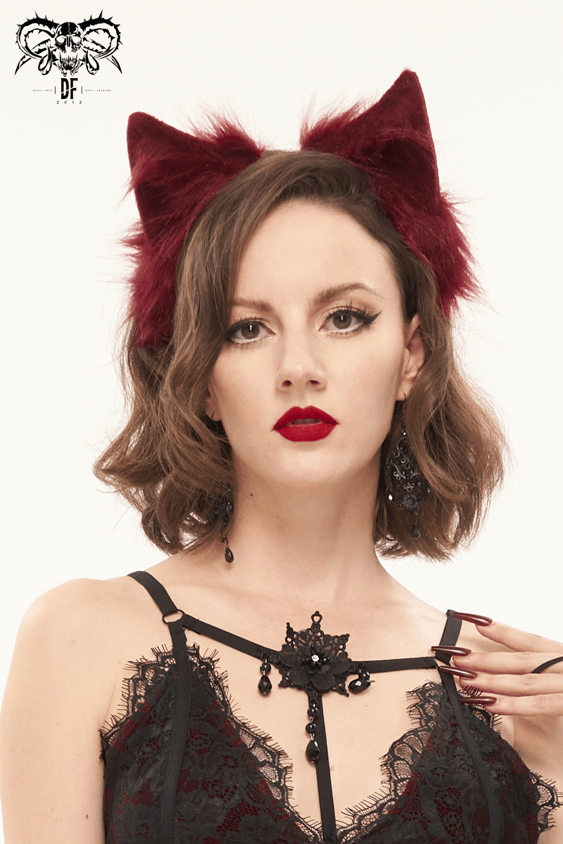 Model wearing red faux fur cat ears headdress, styled with gothic outfit and dark lipstick for a trendy look.