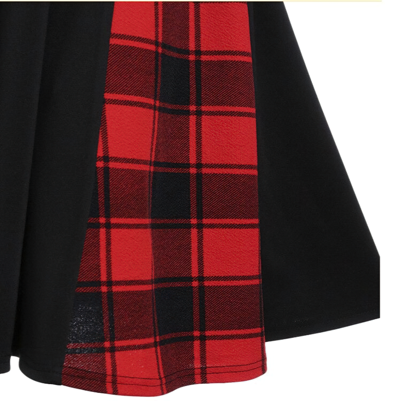 Close-up of a stylish red plaid insert on a black gothic dress, perfect for a retro look.