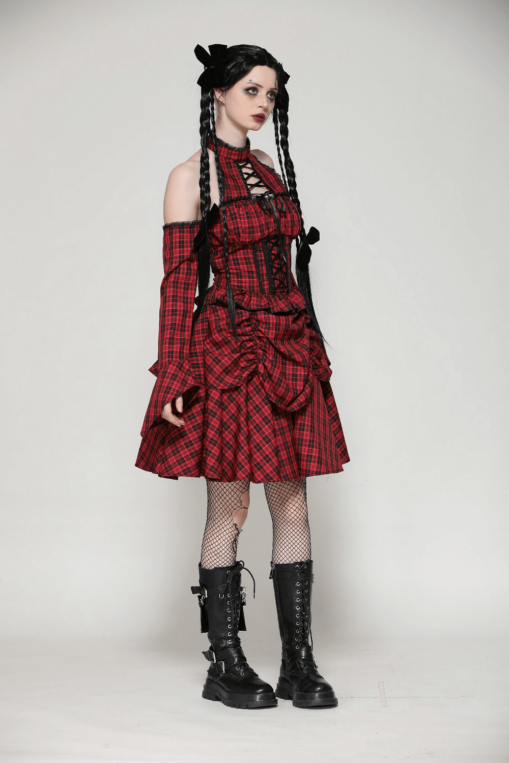 Gothic red plaid corset dress with ruffles, off-shoulder sleeves, and lace-up details, styled with combat boots.