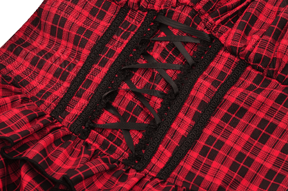 Close-up of the lace-up front detail on a red plaid gothic corset dress with black ruffles. Perfect for bold gothic style!