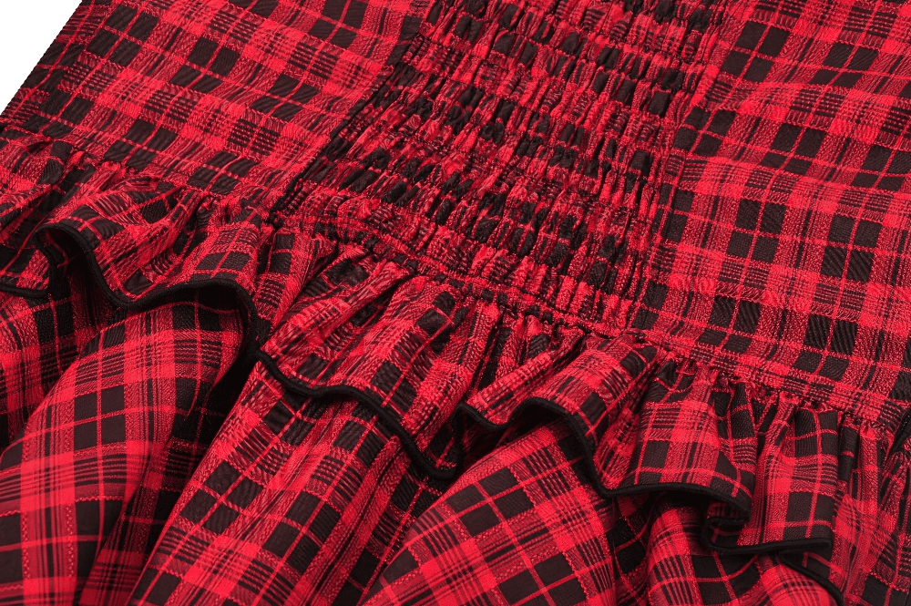 Close-up of red plaid fabric with ruffle details, showcasing the gothic style and Victorian charm of the corset dress.