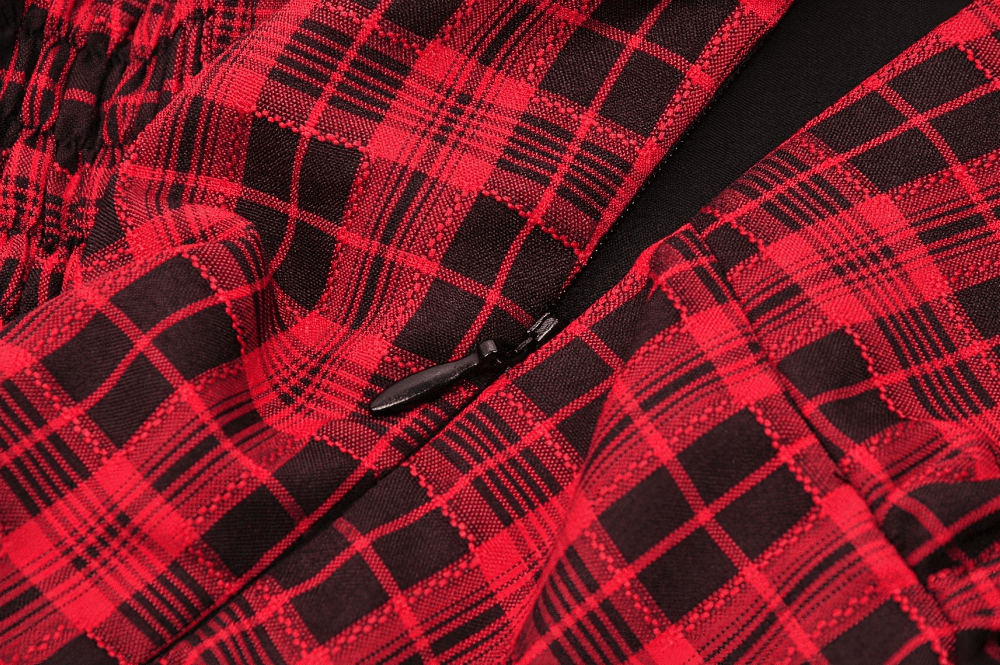 Close-up of red plaid fabric with black accents showcasing the intricate pattern of a gothic corset dress.