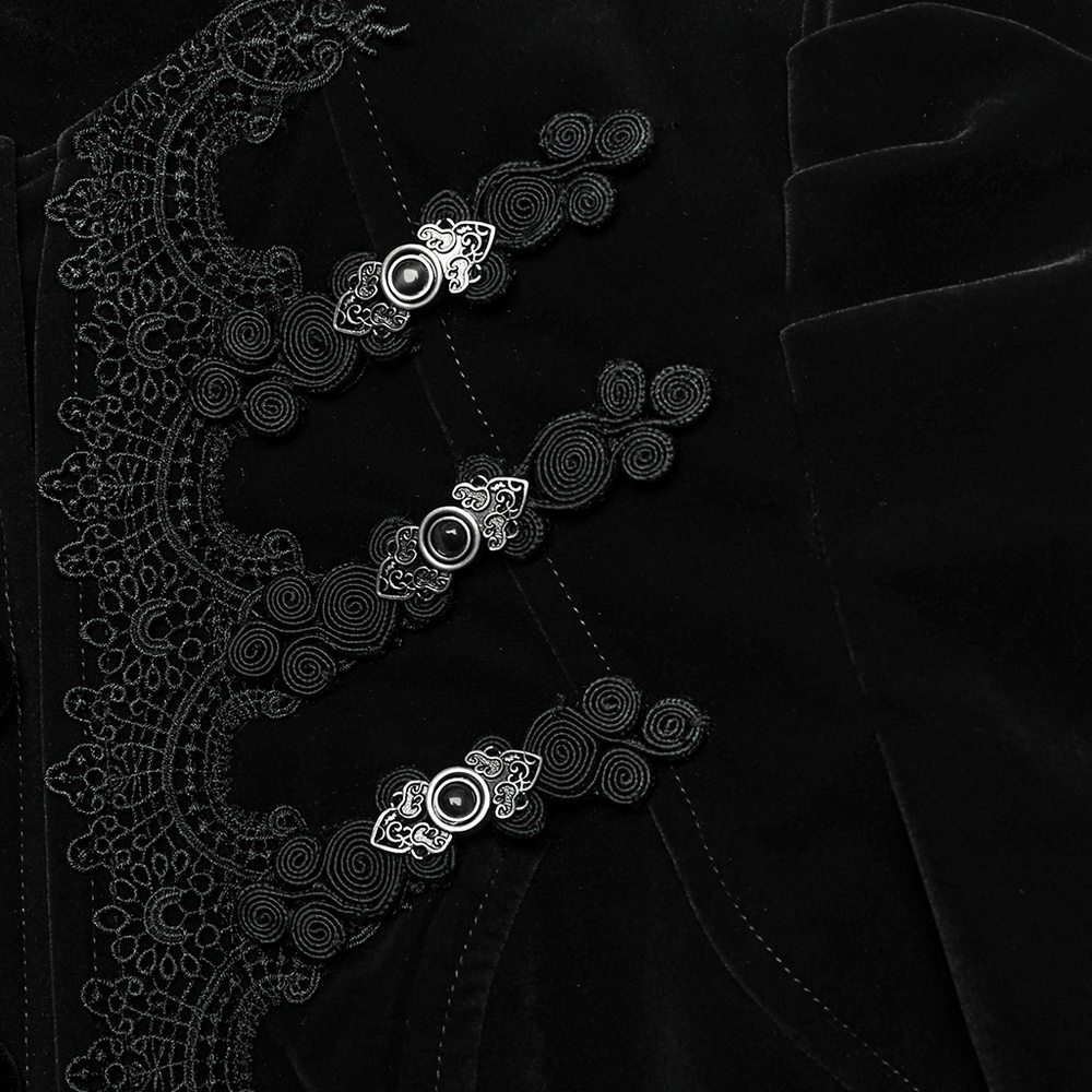 Close-up of gothic black jacket with intricate lace and engraved buttons, showcasing dark elegance and detailed craftsmanship.