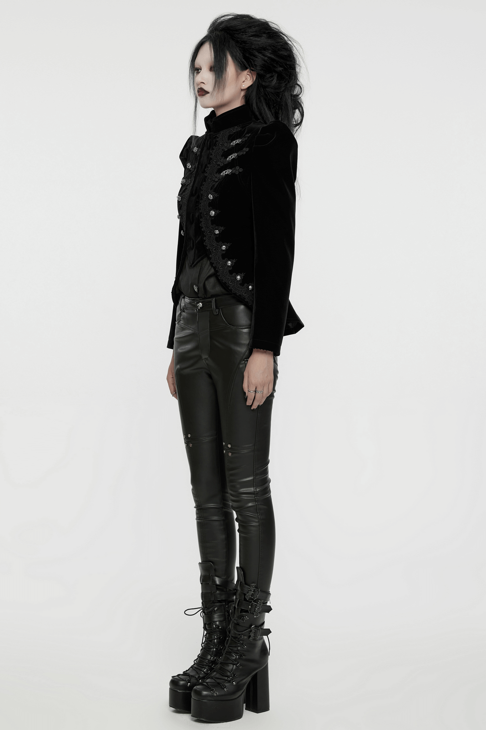 Gothic black velvet jacket with lace and buttons, paired with sleek black leather pants and platform boots.