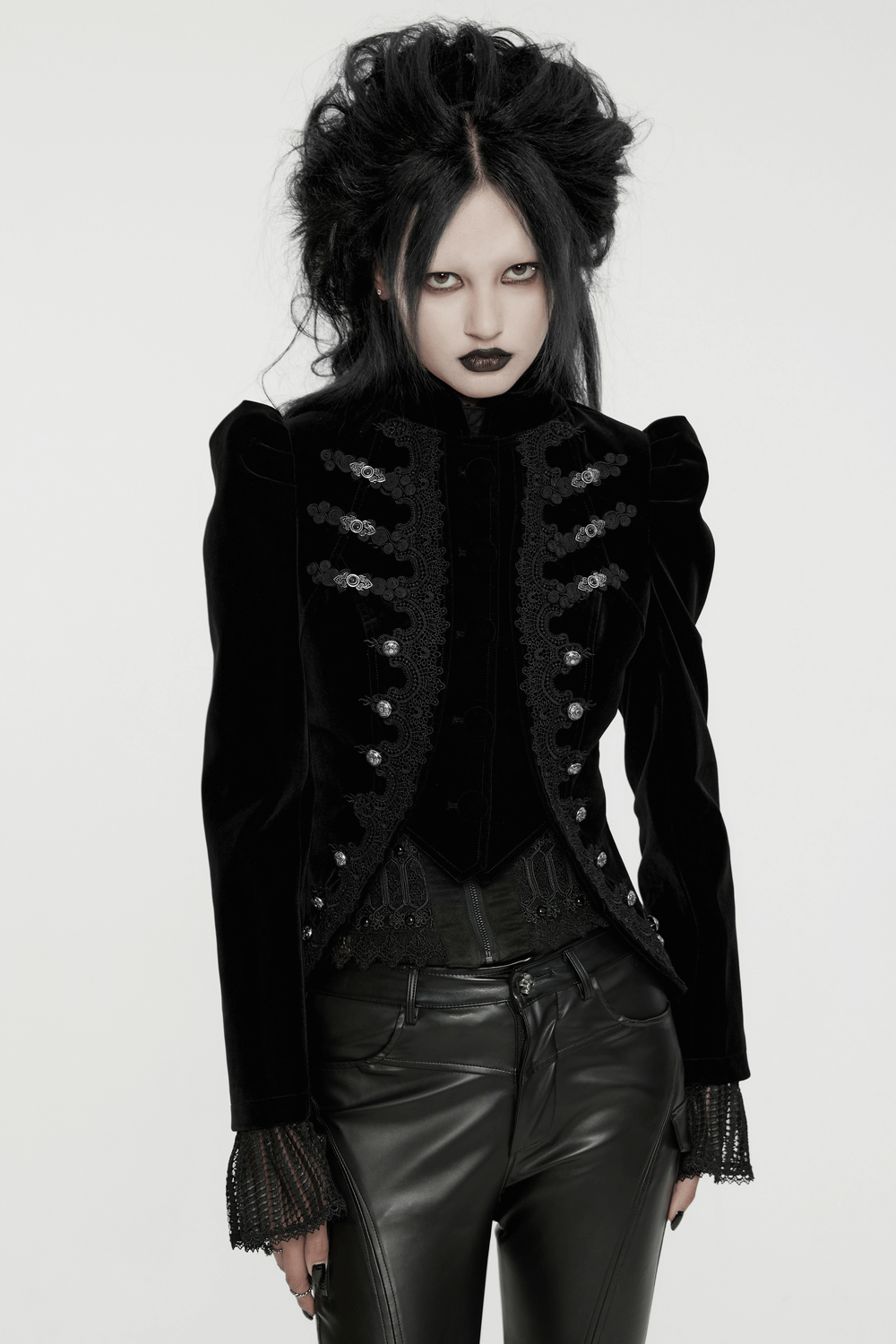 Gothic black velvet jacket with lace and buttons, showcasing a dramatic silhouette and intricate design details.
