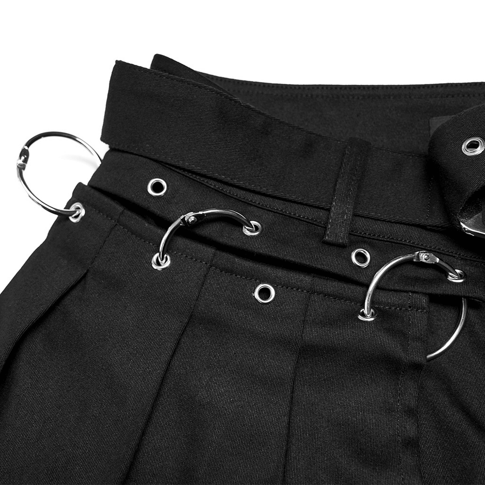 Close-up of removable belt with crimped details on chic black flared punk pants.