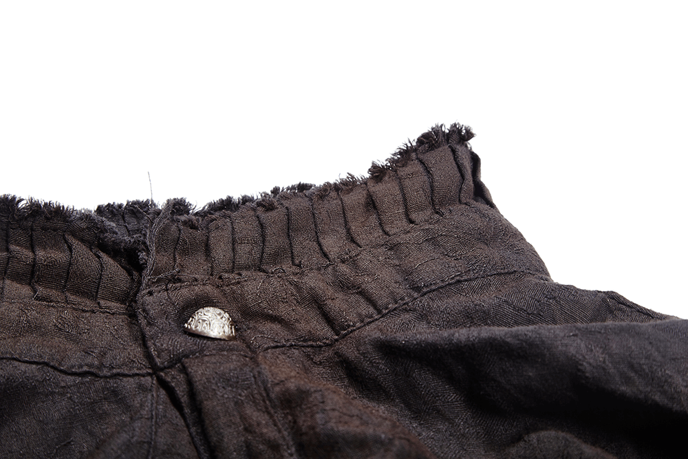 Close-up of the textured collar and button details on a Victorian-inspired linen shirt.
