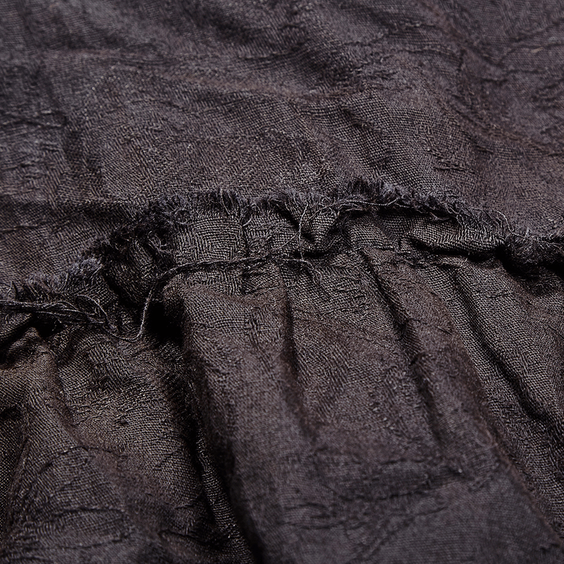 Close-up of textured dark linen fabric showcasing a unique wash for a retro steampunk shirt.