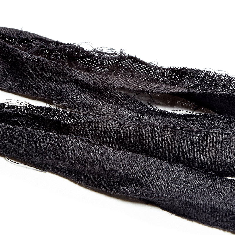 Close-up of black linen fabric strips with frayed edges, perfect for steampunk clothing accents or DIY projects.