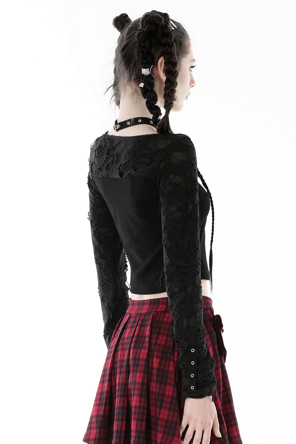 Back view of a black ripped long sleeves crop top with lace detailing paired with a plaid skirt, showcasing an edgy style.