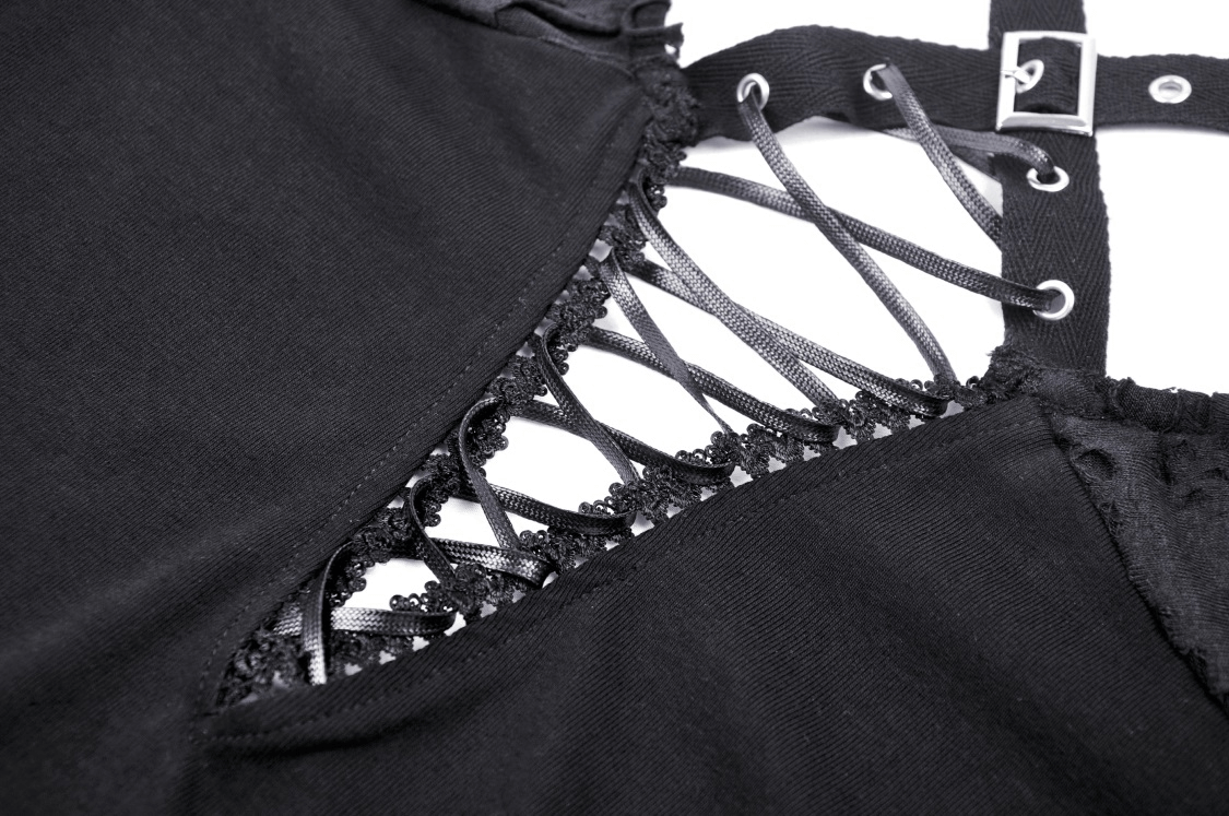 Close-up of a black crop top with intricate lace-up back detailing and mesh accents for an edgy look.
