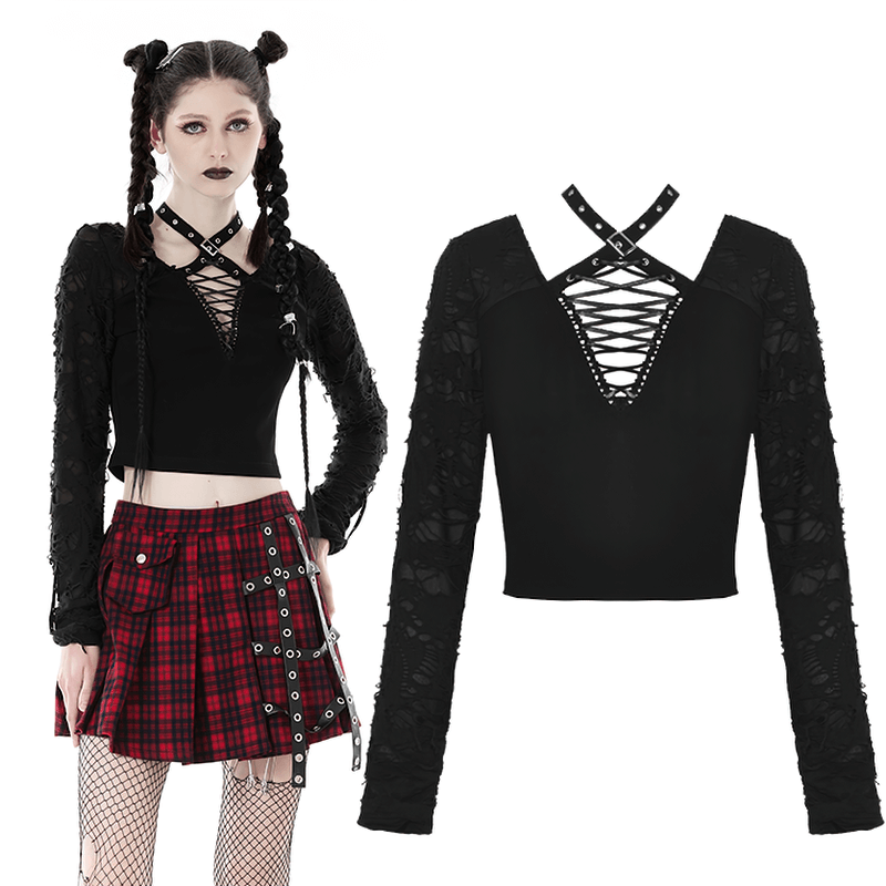 Edgy black ripped long sleeves crop top with statement lacing showcased on model in plaid skirt.