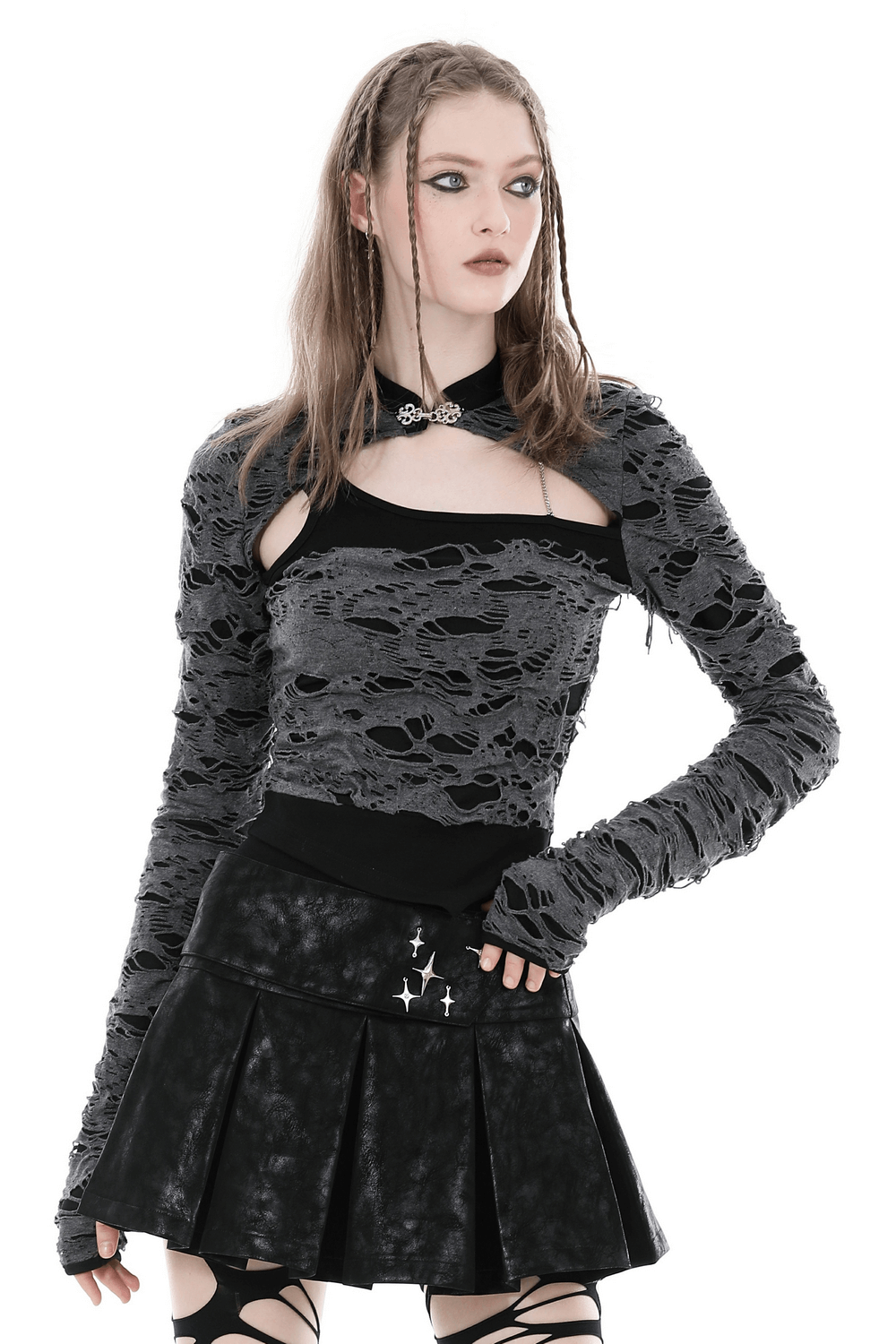 Ripped mesh long-sleeved top with metal eyelets, black mesh crop top styled with a punk rock aesthetic.