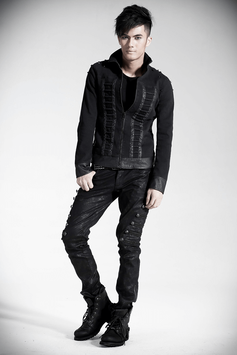 Stylish male model in rock-inspired outfit with embellished jacket and punk jeans, showcasing edgy fashion statement.