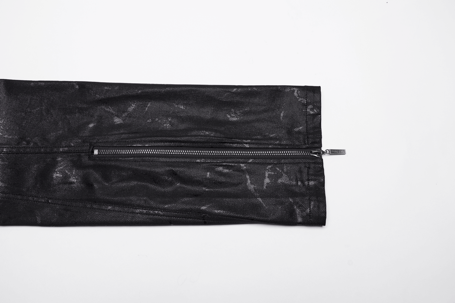 Close-up of stylish black punk rock jeans featuring a sleek zipper detail.