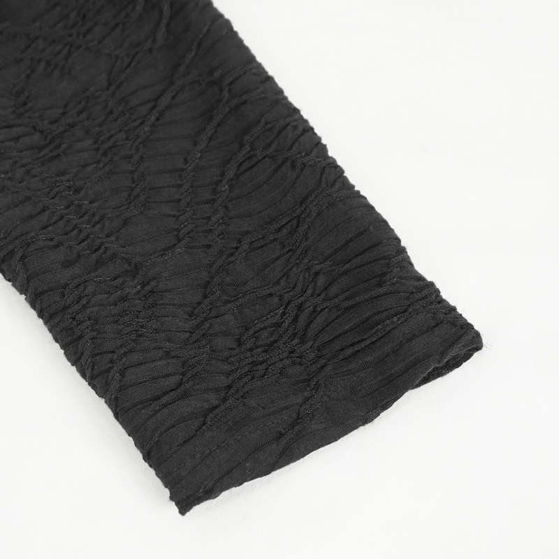 Close-up of textured black fabric showcasing unique pattern, perfect for a rock style top with attitude.
