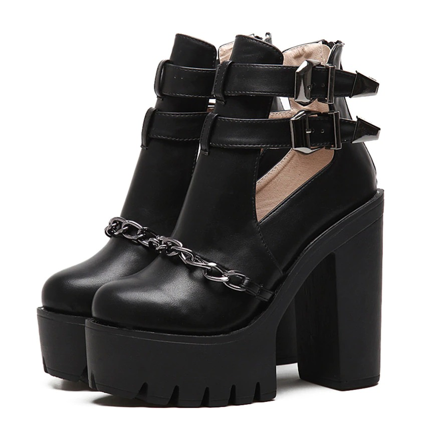 Black high heel boots with chain and buckles, perfect for rocker outfits and concert wear.