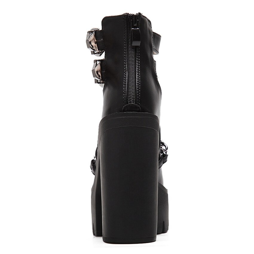 Black leather high heel boots with chain detail and thick platform, perfect for rocker outfits.