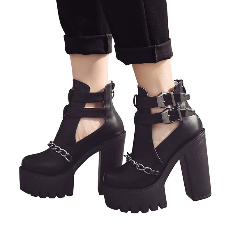 Rock style black high heel boots with chain and buckle, perfect for concert outfits.