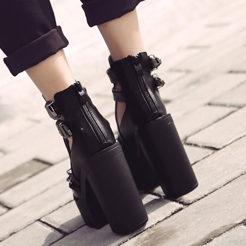 Black high heel boots with thick platform and buckle detail, perfect for rocker outfits and concert style.