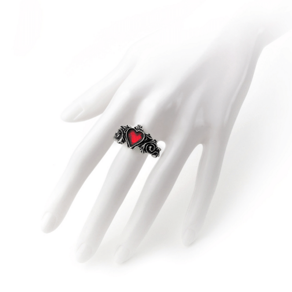 Romantic Gothic ring with red heart and floral design showcased on a hand model.