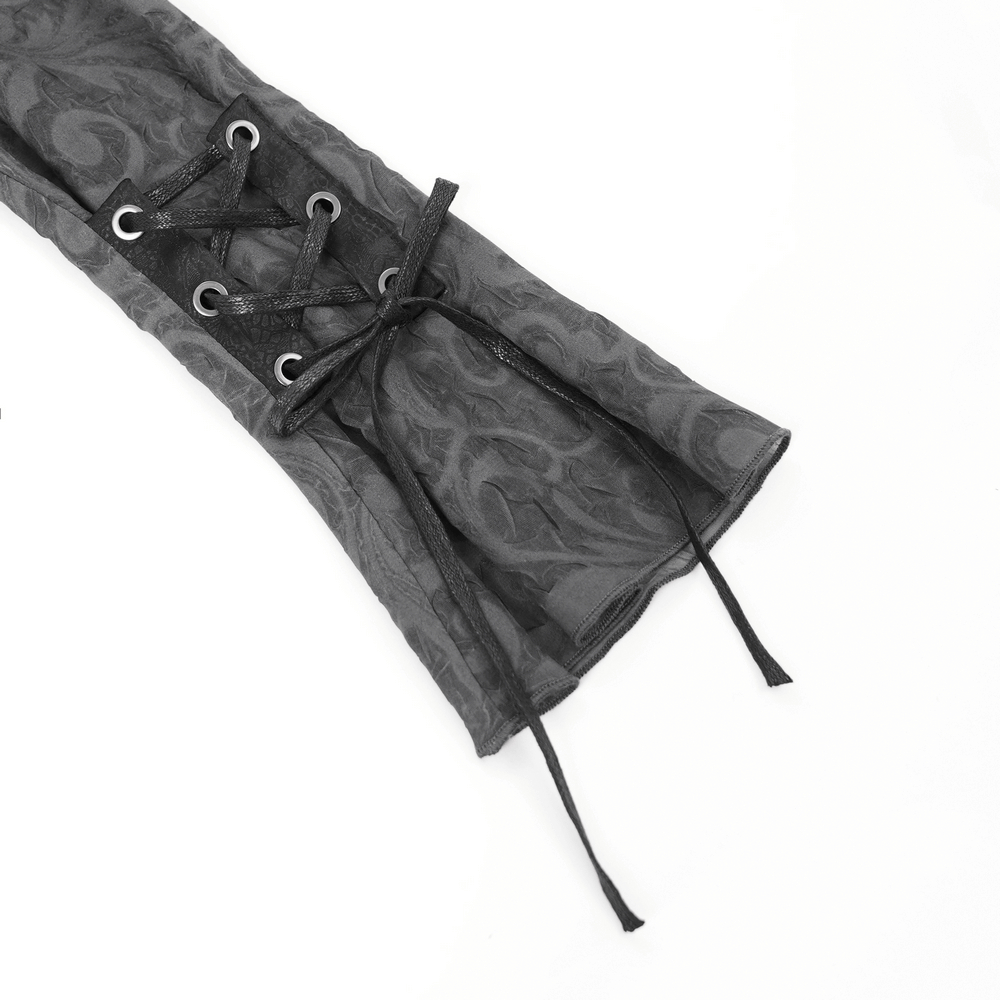 Close-up of lace-up detail on a dark goth sheer blouse with flared sleeves and floral pattern.
