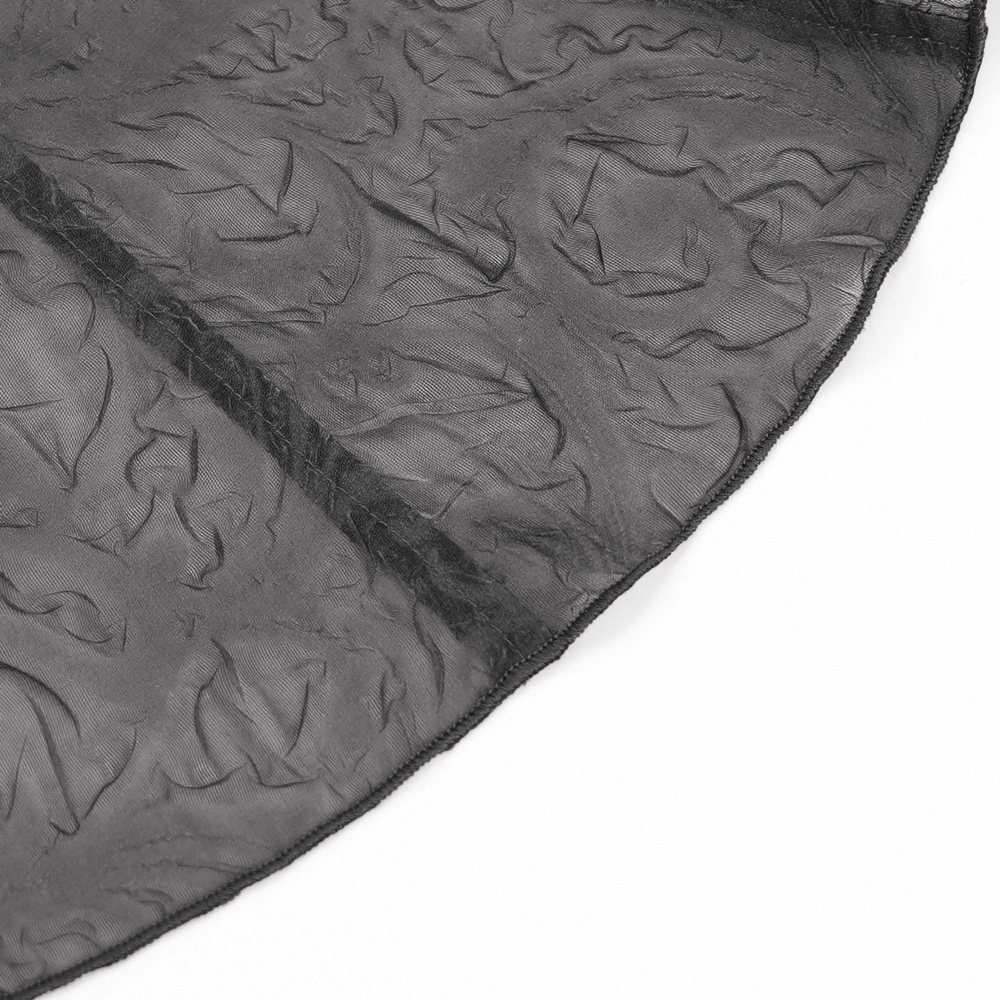 Close-up of romantic sheer black mesh fabric with textured floral pattern for gothic blouse design.