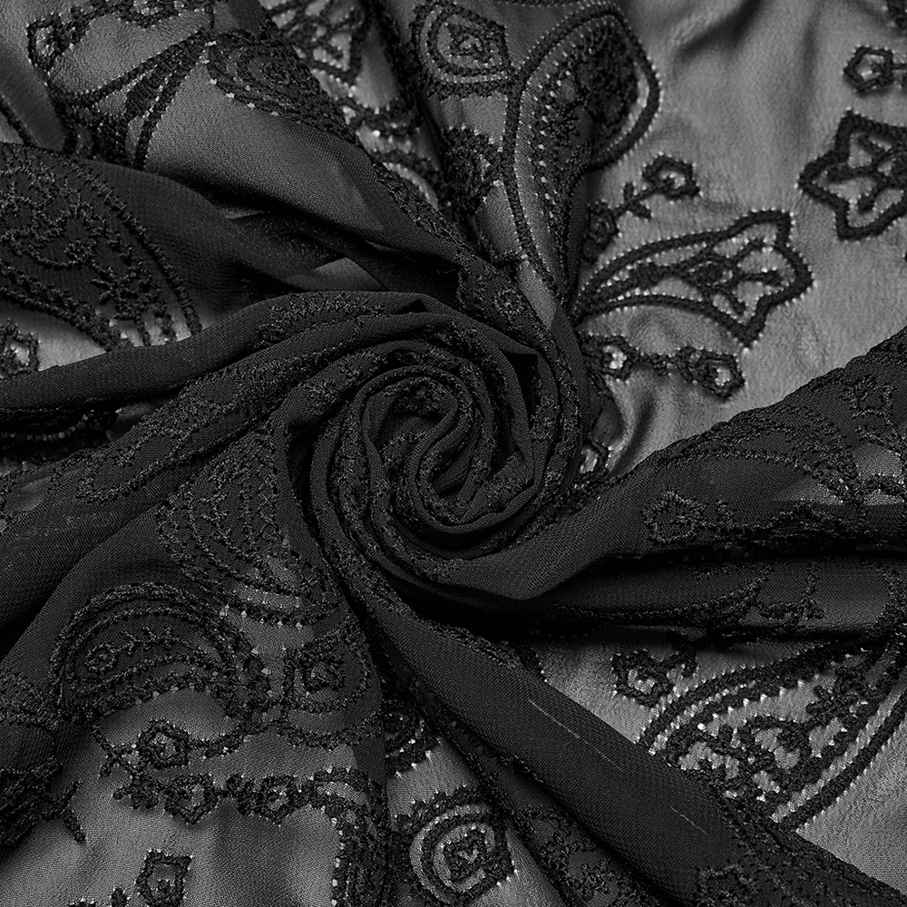Close-up of intricate black embroidered chiffon fabric showcasing a beautiful cashew flower pattern.