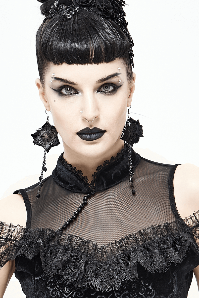 Gothic style model wearing black rose earrings and dramatic makeup, showcasing alternative fashion jewelry.