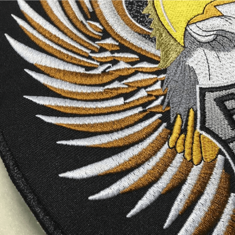 Close-up of a large eagle wing embroidered patch featuring intricate details and vibrant colors for jackets.