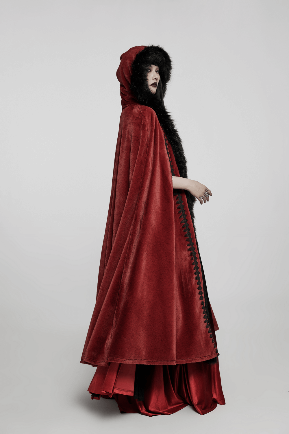 Elegant red velvet Gothic cloak with faux fur hood, perfect for adding drama and warmth to any outfit.