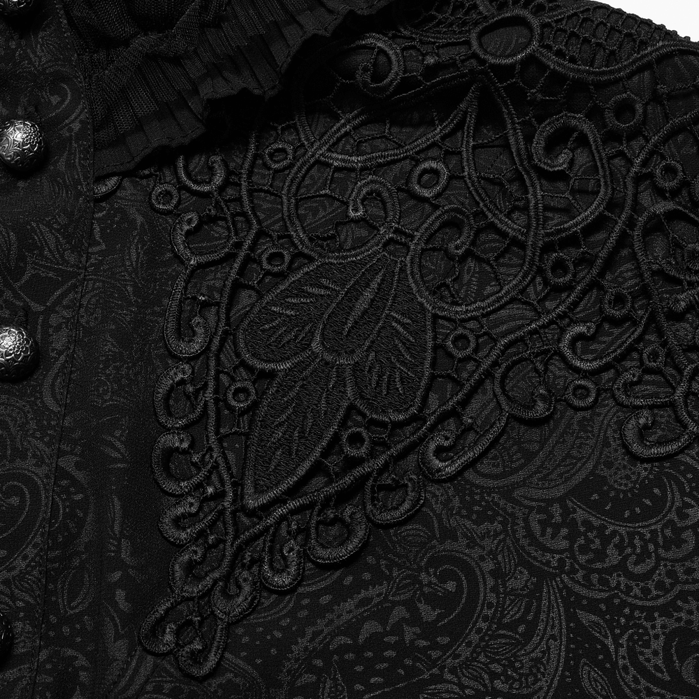 Close-up of intricate black applique detail on a ruffled gothic shirt with elegant patterns and buttons.