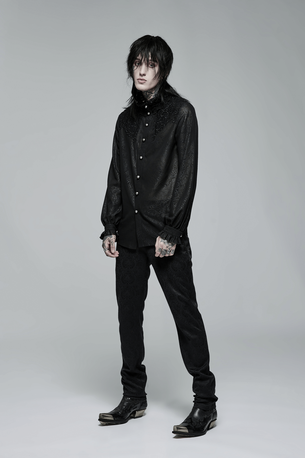 Chic model showcasing a ruffled gothic shirt with printed sleeves and intricate applique details.