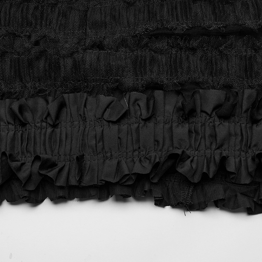 Close-up of ruffled black fabric from a gothic skirt, showcasing layered textures and unique mesh details.