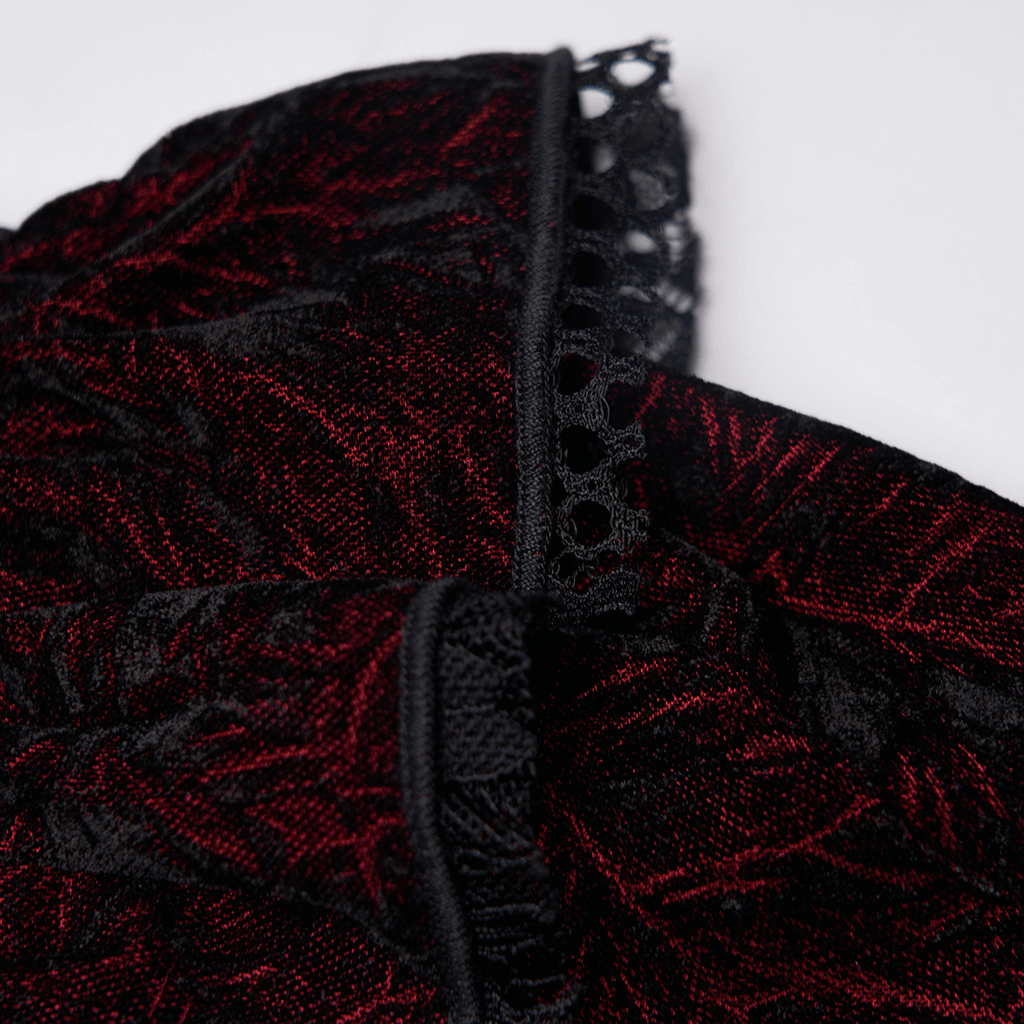 Close-up of ruffled velvet in deep red with intricate lace trim, showcasing gothic elegance and rich texture.