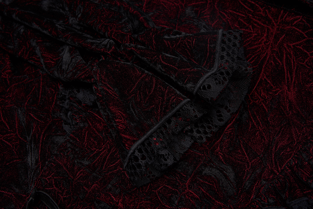 Close-up of ruffled velvet fabric in dark red and black with intricate lace details for a Gothic women's blouse.