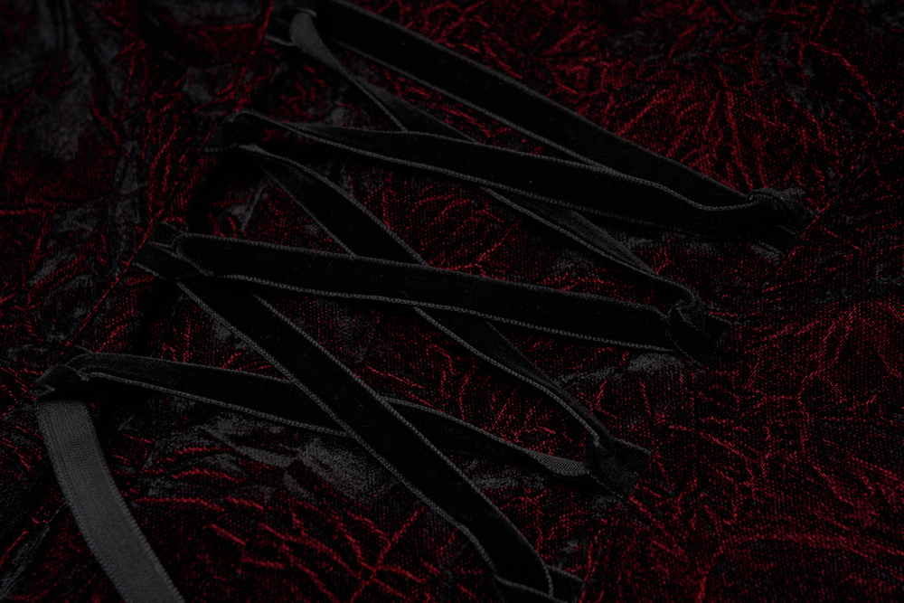 Close-up of the lace-up back detail on a ruffled velvet Gothic blouse, showcasing dark romantic elegance.