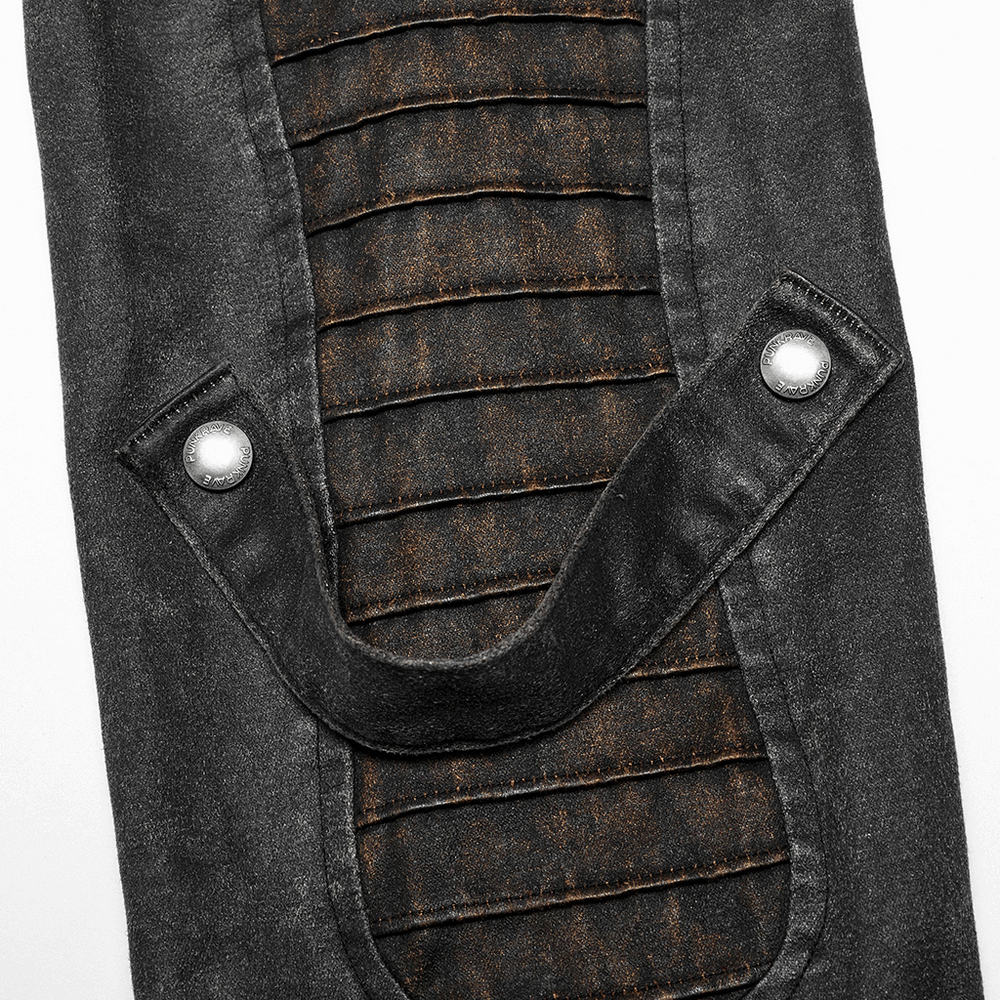 Close-up of textured faux leather jacket sleeve with decorative loops and rivets.