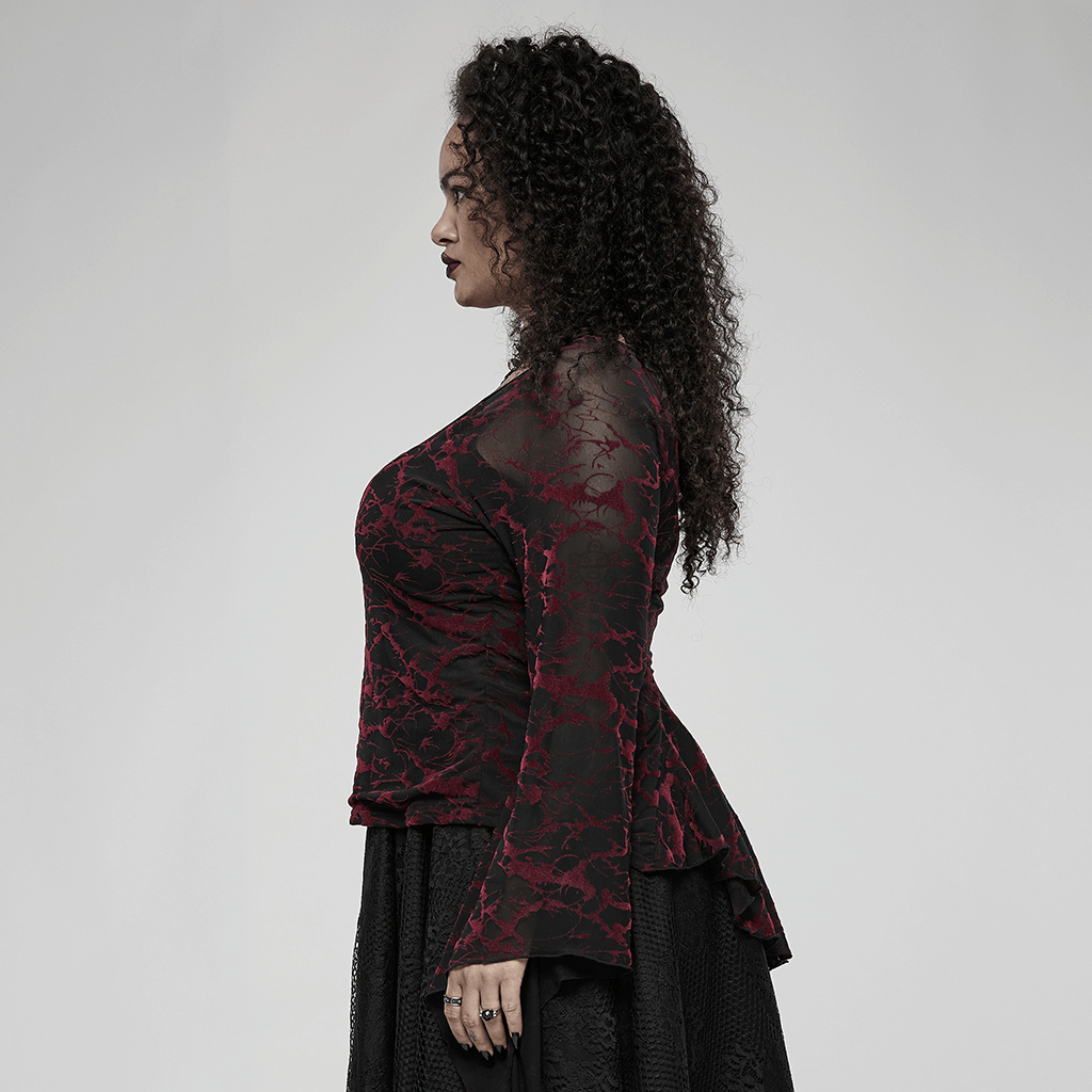 Profile view of a woman modeling a scarlet abstract V-neck mesh goth top with flared cuffs.